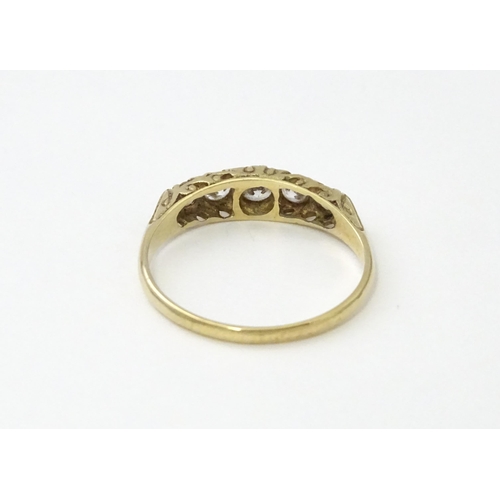 560 - A 9ct gold ring set with five white stones in a linear setting. Ring size approx. O 1/2