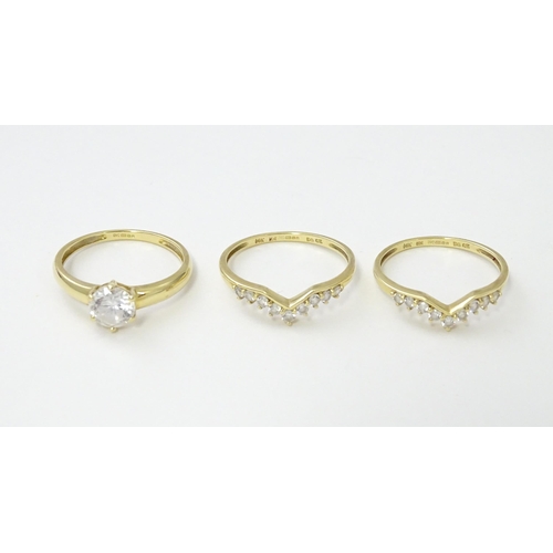 563 - Three 14ct gold rings set with white stones to be worn together. Ring size approx. R 1/2 (3)