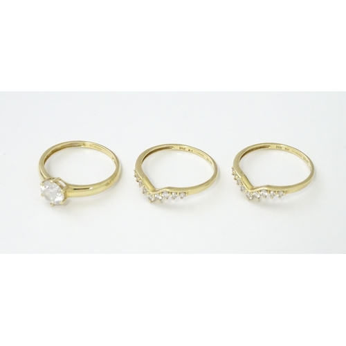 563 - Three 14ct gold rings set with white stones to be worn together. Ring size approx. R 1/2 (3)