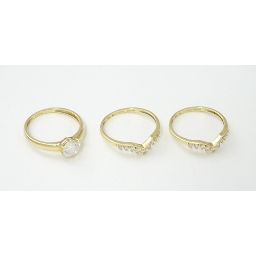 563 - Three 14ct gold rings set with white stones to be worn together. Ring size approx. R 1/2 (3)