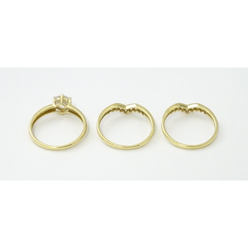 563 - Three 14ct gold rings set with white stones to be worn together. Ring size approx. R 1/2 (3)