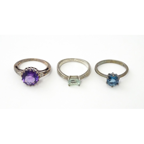 564 - Three silver rings set with various stones. Ring size approx. N 1/2 (3)