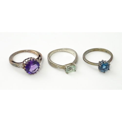 564 - Three silver rings set with various stones. Ring size approx. N 1/2 (3)