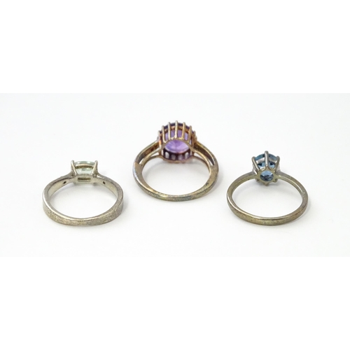 564 - Three silver rings set with various stones. Ring size approx. N 1/2 (3)