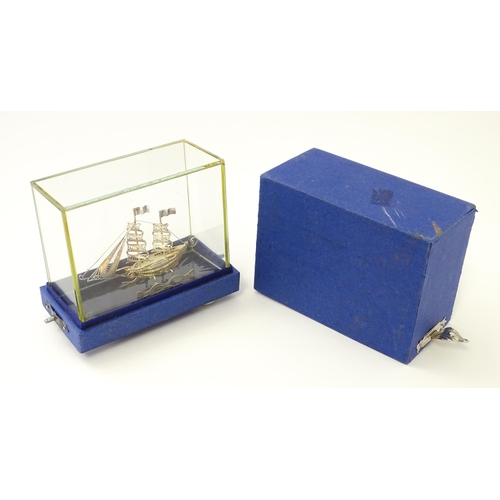 233 - A silver model of a twin masted ship / boat with filigree detail. Marked .925 . The case approx. 4