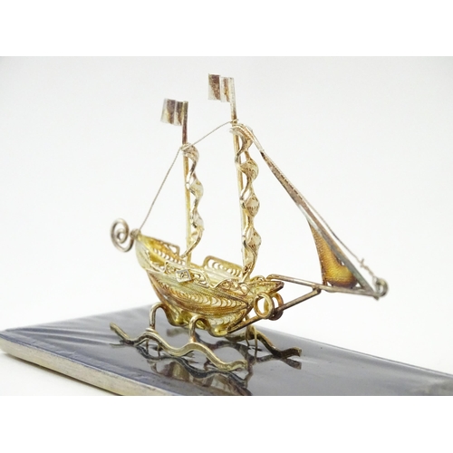 233 - A silver model of a twin masted ship / boat with filigree detail. Marked .925 . The case approx. 4