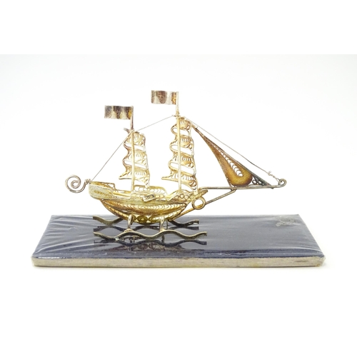 233 - A silver model of a twin masted ship / boat with filigree detail. Marked .925 . The case approx. 4