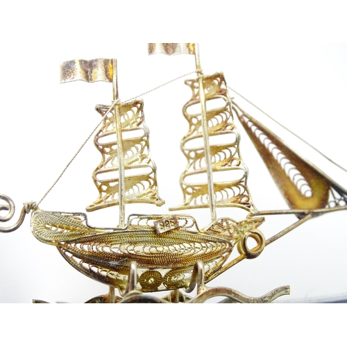 233 - A silver model of a twin masted ship / boat with filigree detail. Marked .925 . The case approx. 4