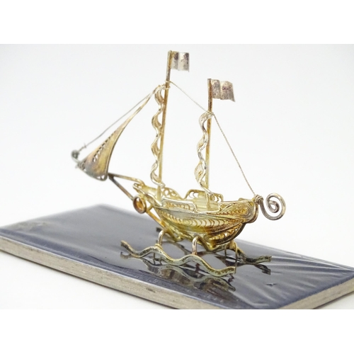 233 - A silver model of a twin masted ship / boat with filigree detail. Marked .925 . The case approx. 4