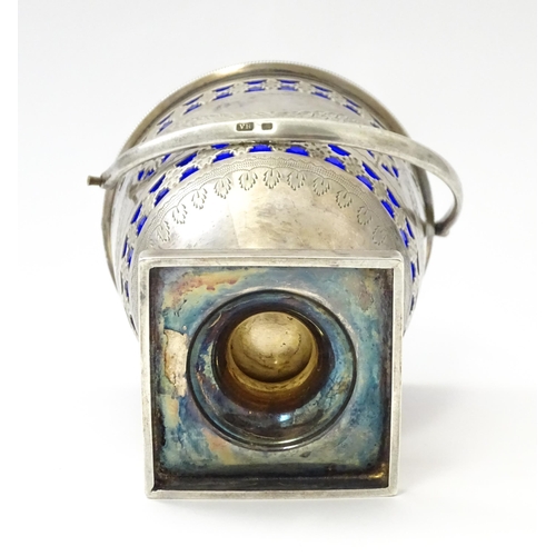 242 - A Victorian silver sugar bowl with swing handle, engraved bright cut decoration and blue glass liner... 