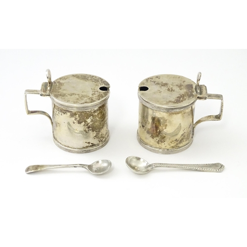 252 - A matched pair of silver mustard pots, one hallmarked London 1930, maker Goldsmiths & Silversmiths C... 