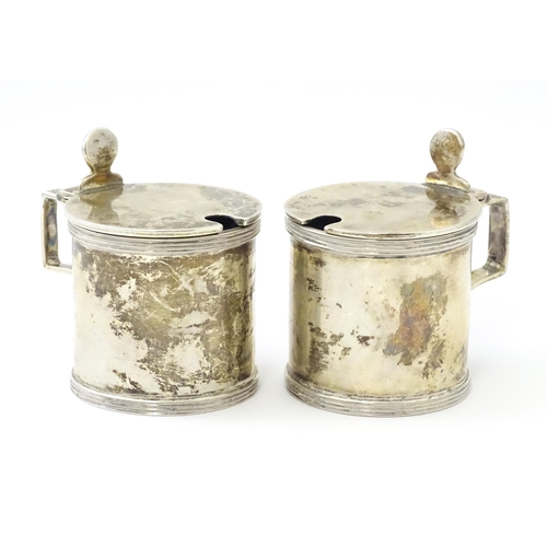 252 - A matched pair of silver mustard pots, one hallmarked London 1930, maker Goldsmiths & Silversmiths C... 