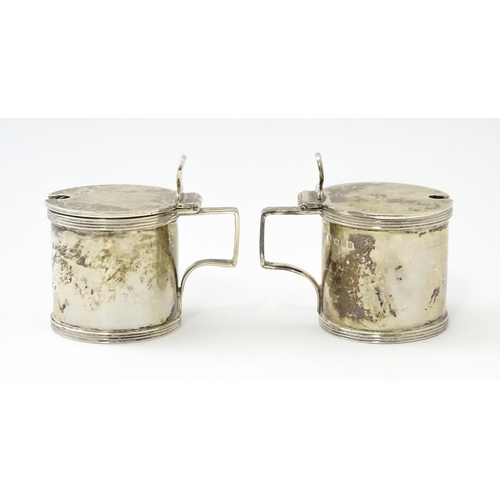 252 - A matched pair of silver mustard pots, one hallmarked London 1930, maker Goldsmiths & Silversmiths C... 