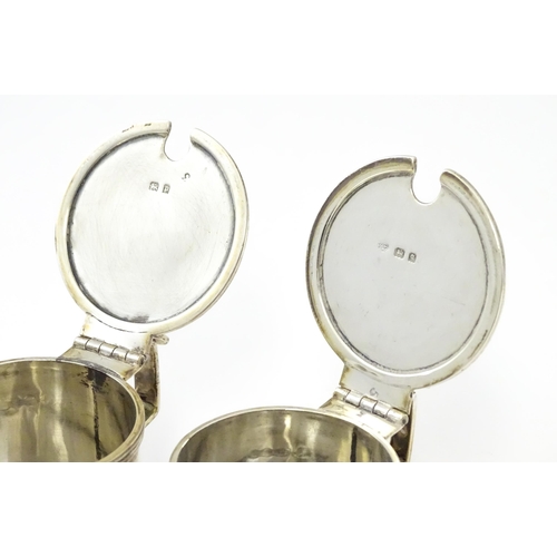 252 - A matched pair of silver mustard pots, one hallmarked London 1930, maker Goldsmiths & Silversmiths C... 