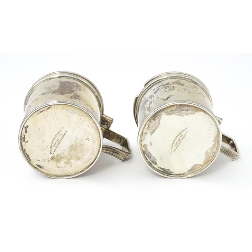 252 - A matched pair of silver mustard pots, one hallmarked London 1930, maker Goldsmiths & Silversmiths C... 