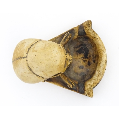 1218 - A 20thC composite Memento Mori ashtray with skull and crossed bone detail. Approx. 4