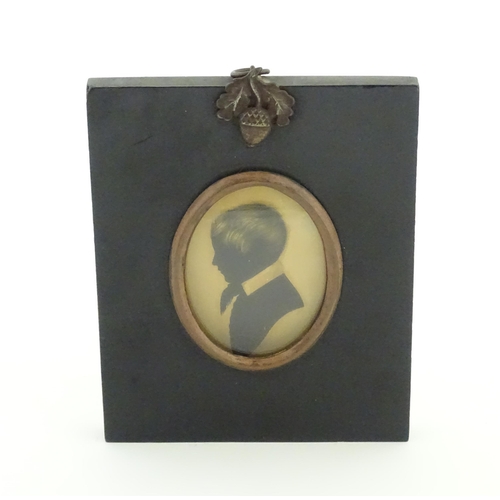 1237 - A 19thC silhouette portrait miniature depicting a young boy in profile, with gilt highlights. Approx... 