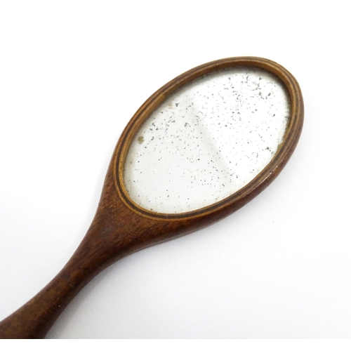 1240 - A Victorian miniature hand mirror with a mahogany surround. Approx. 4