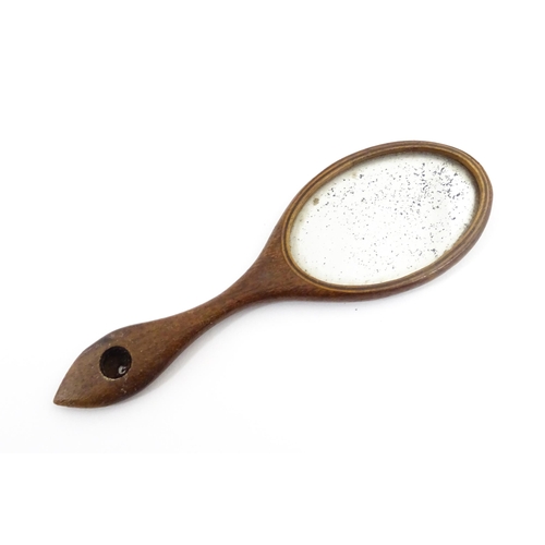 1240 - A Victorian miniature hand mirror with a mahogany surround. Approx. 4