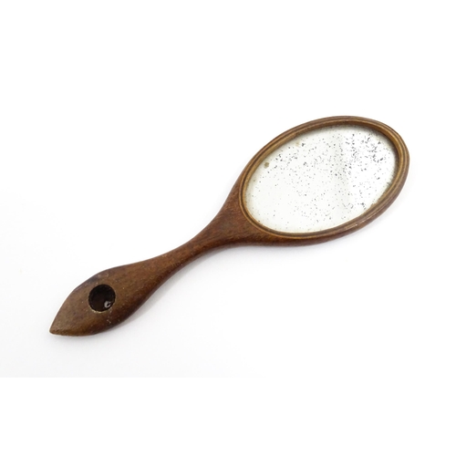 1240 - A Victorian miniature hand mirror with a mahogany surround. Approx. 4