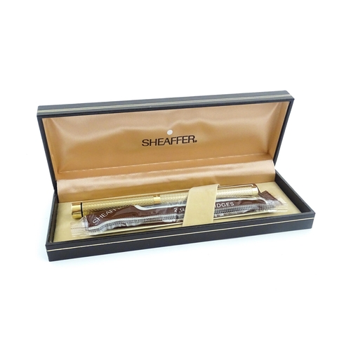 1272 - A cased Sheaffer 'Targa 1009' fountain pen with gold plated chequered barrel and cap, 14ct gold nib,... 