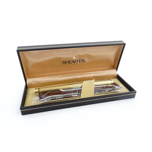 1272 - A cased Sheaffer 'Targa 1009' fountain pen with gold plated chequered barrel and cap, 14ct gold nib,... 