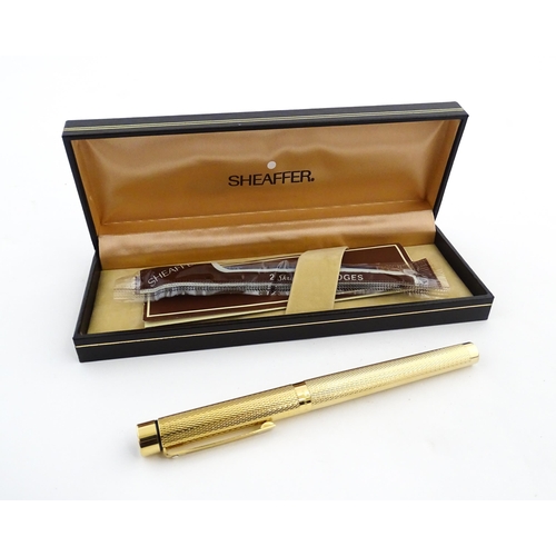 1272 - A cased Sheaffer 'Targa 1009' fountain pen with gold plated chequered barrel and cap, 14ct gold nib,... 