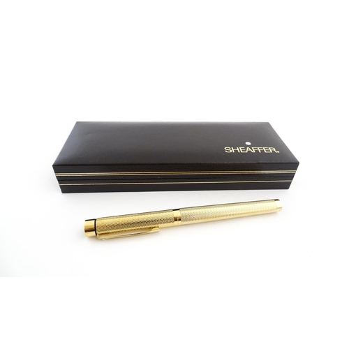 1272 - A cased Sheaffer 'Targa 1009' fountain pen with gold plated chequered barrel and cap, 14ct gold nib,... 