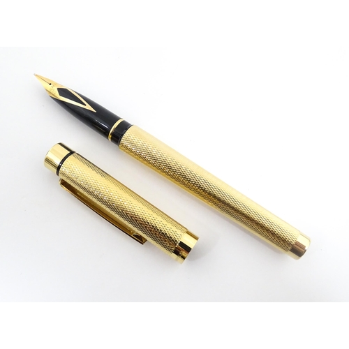 1272 - A cased Sheaffer 'Targa 1009' fountain pen with gold plated chequered barrel and cap, 14ct gold nib,... 