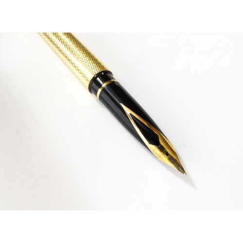 1272 - A cased Sheaffer 'Targa 1009' fountain pen with gold plated chequered barrel and cap, 14ct gold nib,... 