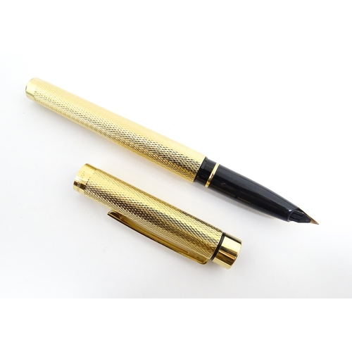 1272 - A cased Sheaffer 'Targa 1009' fountain pen with gold plated chequered barrel and cap, 14ct gold nib,... 