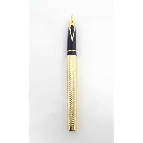 1272 - A cased Sheaffer 'Targa 1009' fountain pen with gold plated chequered barrel and cap, 14ct gold nib,... 