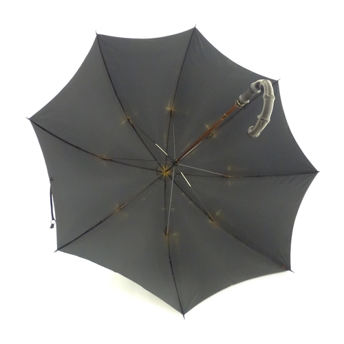 1297 - An early 20thC Paragon S. Fox & Co parasol / umbrella with ebonised handle, bearing label to spoke. ... 