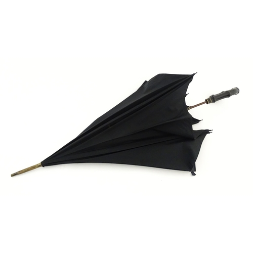 1297 - An early 20thC Paragon S. Fox & Co parasol / umbrella with ebonised handle, bearing label to spoke. ... 