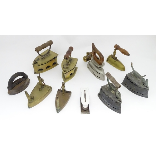 1306 - A quantity of assorted 19thC and later cast brass and iron flat irons, to include Feldmeyer spirit i... 