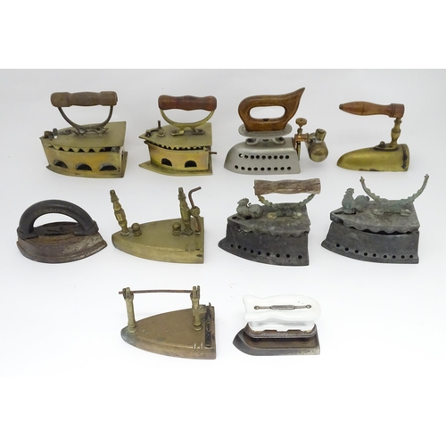 1306 - A quantity of assorted 19thC and later cast brass and iron flat irons, to include Feldmeyer spirit i... 