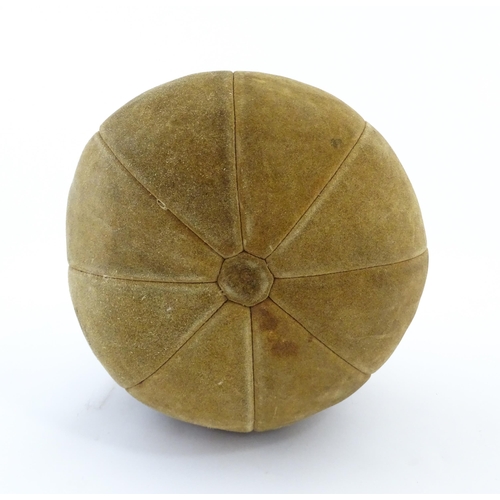 1324 - A 20thC suede medicine training ball. Approx. 11