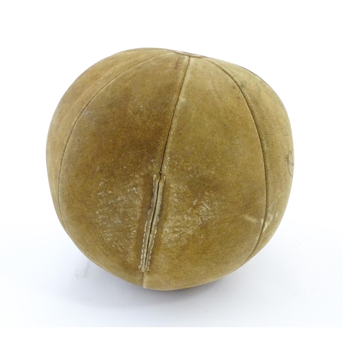 1324 - A 20thC suede medicine training ball. Approx. 11