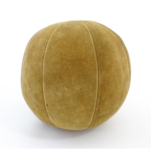 1324 - A 20thC suede medicine training ball. Approx. 11