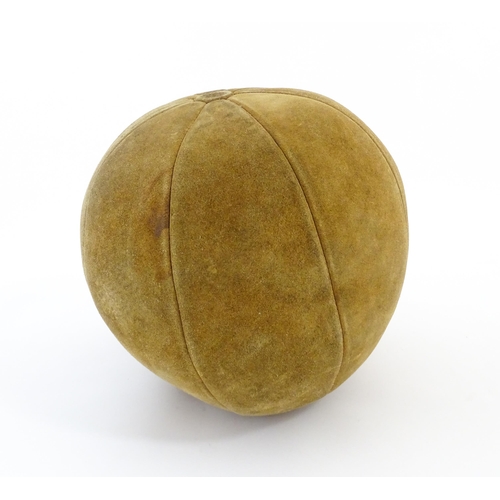 1324 - A 20thC suede medicine training ball. Approx. 11