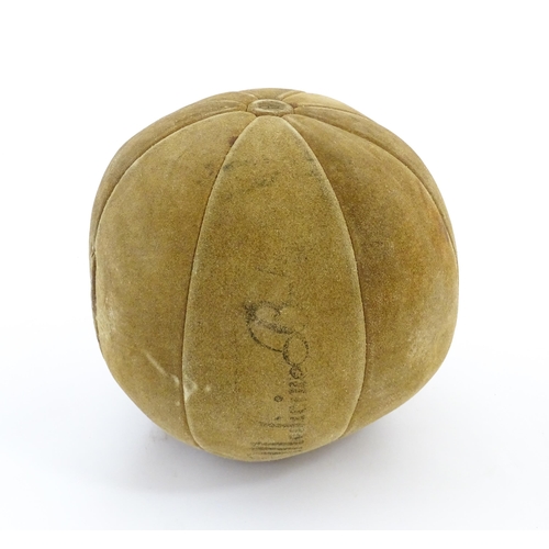 1324 - A 20thC suede medicine training ball. Approx. 11