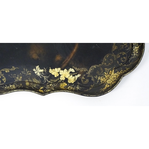 1325 - A Victorian papier-mache tray with a moulded edge and gilt painted floral decoration. Stamped B. Wal... 