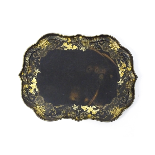 1325 - A Victorian papier-mache tray with a moulded edge and gilt painted floral decoration. Stamped B. Wal... 