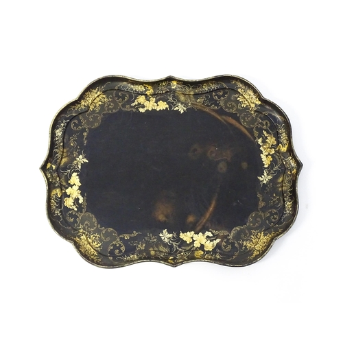 1325 - A Victorian papier-mache tray with a moulded edge and gilt painted floral decoration. Stamped B. Wal... 