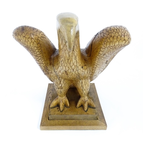 1338 - A 20thC carved wooden model of an eagle with incised feathers and features, by Henry George Pentus B... 