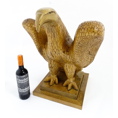 1338 - A 20thC carved wooden model of an eagle with incised feathers and features, by Henry George Pentus B... 