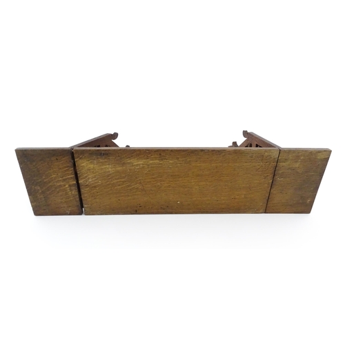 1340 - A Victorian oak extending bookslide / book holder with Gothic fretwork decoration. Approx. 22