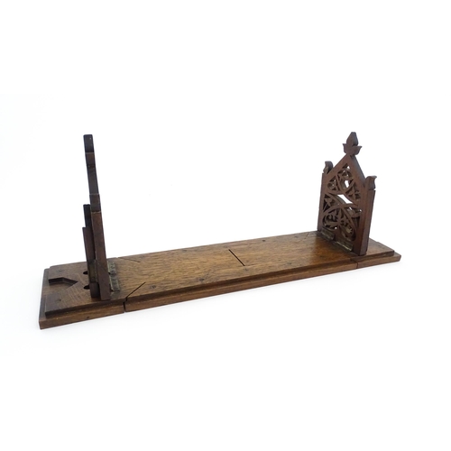 1340 - A Victorian oak extending bookslide / book holder with Gothic fretwork decoration. Approx. 22