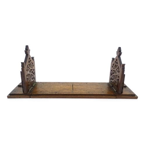 1340 - A Victorian oak extending bookslide / book holder with Gothic fretwork decoration. Approx. 22