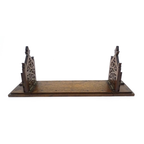 1340 - A Victorian oak extending bookslide / book holder with Gothic fretwork decoration. Approx. 22